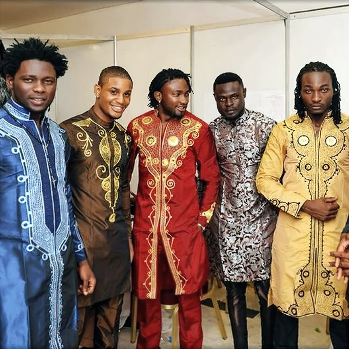 Five men wearing colorful YND dashiki outfits.